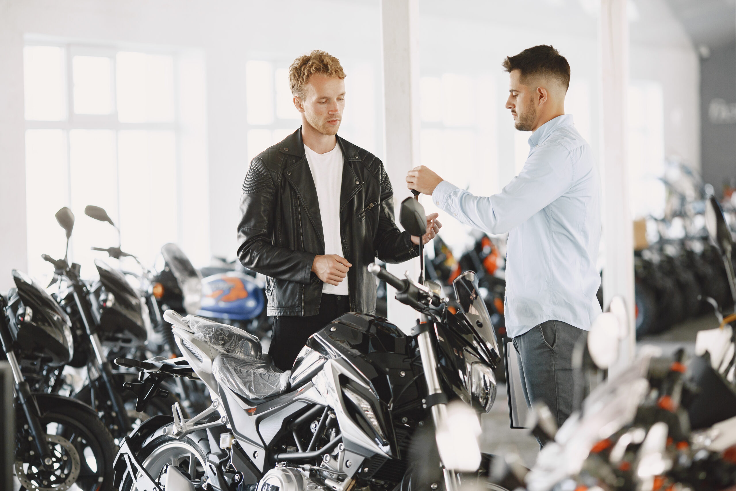 hombre entregando moto a comprador en concesionario – vender moto 2025